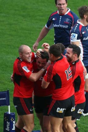Crusaders congratulate Zac Guildford after a try against the Rebels.