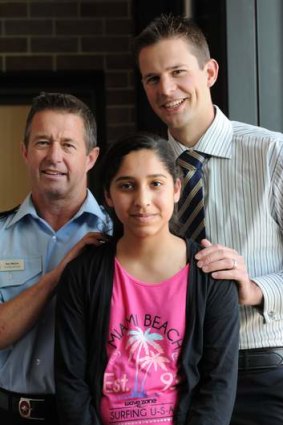 Zartash Sarwar, with her rescuers: ACT Fire and Rescue Station Officer, Neil Maher, left and Constable Paul Reynolds.