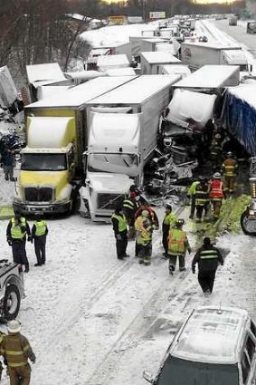 Trucks and passenger vehicles block eastbound Interstate 94 following a massive crash that killed three people and injured about 20 near Michigan City, Indiana.