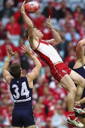 Luke Parker of the Swans climbs highest.