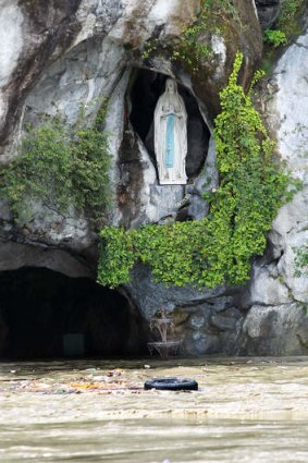 A tyre floats past the flooded grotto of Lourdes, in  south-western France, where heavy floods have forced the closure of the Catholic pilgrimage site.