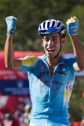 Italy's Fabio Aru, from the Astana team, celebrates as he crosses the finish line to win the 11th stage.