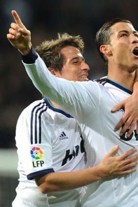 Cristiano Ronaldo celebrates one of his three goals against Sevilla at the weekend with Fabio Coentrao.