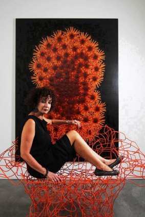 Anna Schwartz on an orange wire chair designed by the Campana brothers.