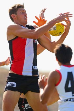 St Kilda's Tom Hickey flies high in an attempt to mark.