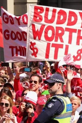 The fans are certainly convinced that Buddy is worth what he is being paid. as this banner at Friday's grand final parade shows.