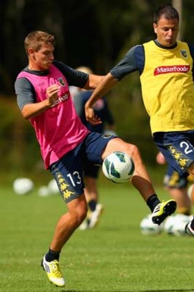 Brent Griffiths and Mile Sterjovski of the Mariners during a training session earlier in the week.