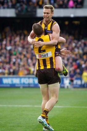 Jump for joy: Sam Mitchell and Jarryd Roughead embrace.