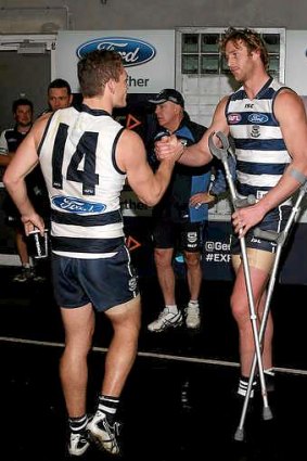 Dawson Simpson (right) of the Cats is consoled by Joel Selwood after he injured his leg during the round 18 AFL match Geelong and St Kilda.