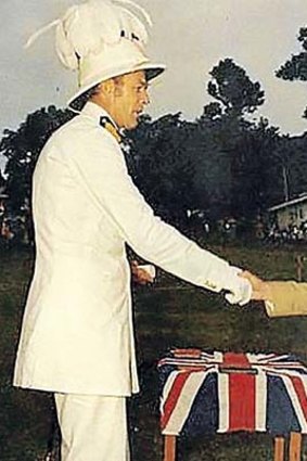 Andrew Stuart receives the British flag on Independence Day.