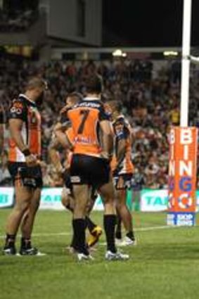 To this: Tigers players downcast after conceding a try to Brisbane on their way to landing at the bottom of the ladder for the first time in the joint venture's history.