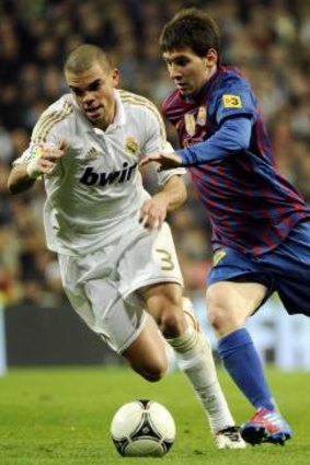 Real Madrid's Pepe with Barcelona's Lionel Messi.