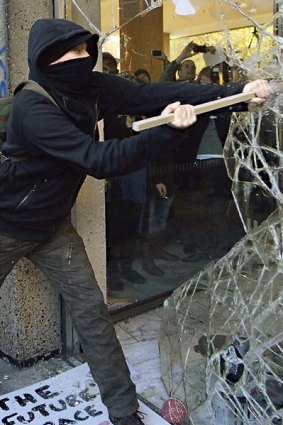 Violence escalated ... one of about 200 demonstrators who attacked the foyer of Millbank Tower.
