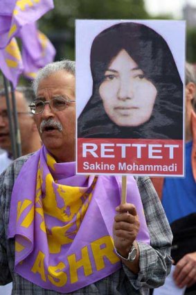 A protestor holds a portrait of Sakineh Mohammadi Ashtiani.