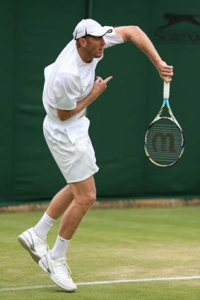 New zone: Chris Guccione serves in a doubles match at Wimbledon.