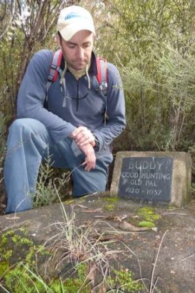 Dave Vincent pays his respects at Buddy’s grave, still marked by a plaque.