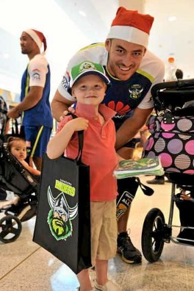 Raiders skipper Terry Campese meets Alexander Brown, 4 of Conder, at Tuggeranong Hyderdome on Monday. Raiders players were handing out junior club memberships.