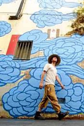 Broad canvas: Artist Jason Wing with his Chinatown street artwork In between Two Worlds.