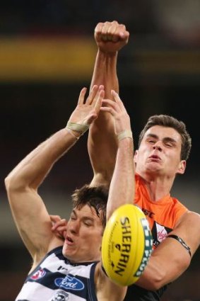 Giant Tom Boyd spoils Andrew Mackie's marking attempt.