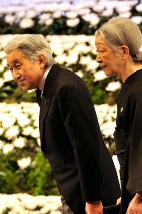 Paying their respects ... Emperor Akihito and Empress Michiko in Tokyo.