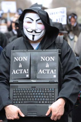 An activist wearing an Anonymous Guy Fawkes mask.