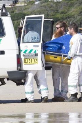 The body of man is removed from Clarkes Beach, Byron Bay NSW after a shark attack.