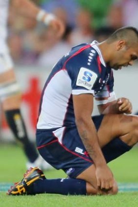 In pain: Melbourne full-back Kurtley Beale slumps to the ground after injuring his shoulder during the Rebels' 30-13 loss against the ACT Brumbies.