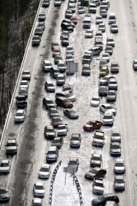 Traffic chaos ... abandoned cars on I-75 are piled up in the median of the ice-covered highway after huge snow storm in Atlanta.