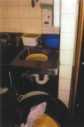Designated hand wash basin showing it is inaccessible and unclean and used for more than solely washing hands.