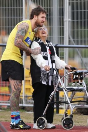 Dane Swan, coming back from a foot injury, greets an adoring fan at Magpies training on Wednesday.