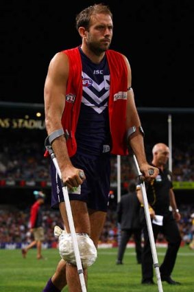 Docker Kepler Bradley heads to the changerooms on crutches at halftime, after injuring his knee during the match against Richmond.