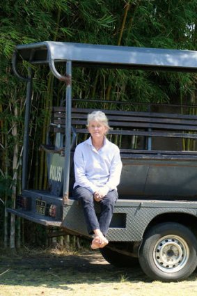 Doing battle: Bali resident Susi Johnston on a police car. Police have been deployed to protect her while her attackers are being tried in court.