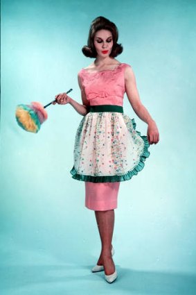 Kitchen couture: A model wears a hostess apron in 1960.
