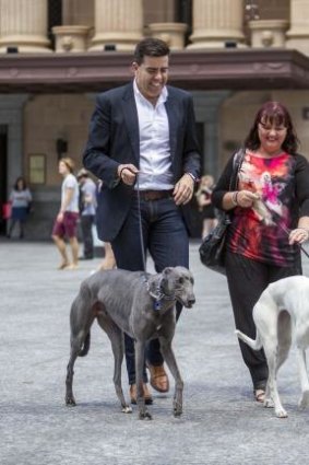 Councillor Milton Dick outside Brisbane Town Hall with Lisa Paxton and her greyhounds Frankie and Chloe.