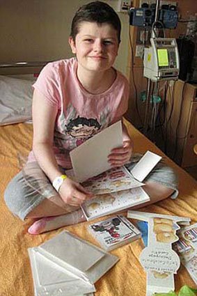 Alice in hospital going through her get-well cards.