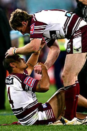 Manly players console each other after their grand final loss in 2007.