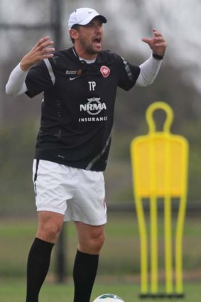 Results in sight ... coach Tony Popovic lays down the law at training on Wednesday.