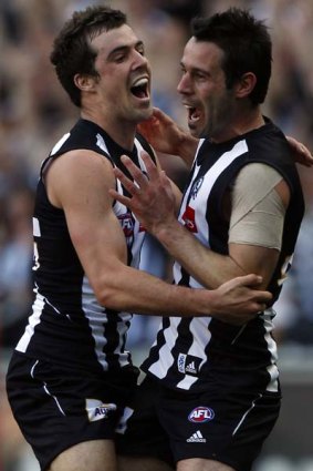 Mercurial Magpies midfielder Alan Didak (right) celebrates with teammate Steele Sidebottom after kicking a goal in the third quarter.