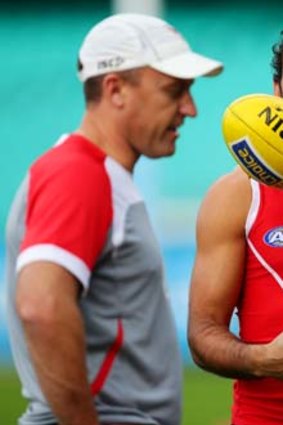 Adam Goodes and Swans coach John Longmire share a moment during training this week.