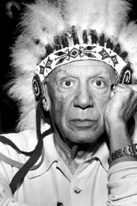 Pablo Picasso wears a native American headress and a Rolex GMT Master on his wrist.
