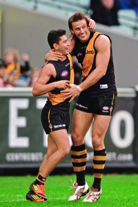 The long and short of it. Richmond small forward Robin Nahas celebrates a goal by ruckman Ivan Maric against the Hawks.