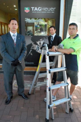 Pino Martello and Joel Smales with Michael Ryan minutes before he pulled down Smales Jewellers' Tiger Woods placard.