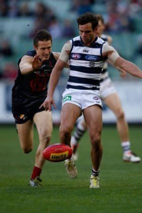 Demon Jack Grimes arrives a fraction too late to tackle Geelong's Steven Motlop. 