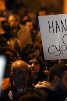Outrage: Cypriots protest outside parliament in Nicosia.