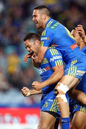 All aboard the Hayne plane: Jarryd Hayne is the centre of attention after scoring for Parramatta.