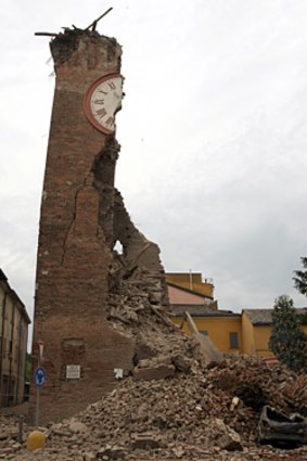 Cars damaged after a tower collapsed following an earthquake in Finale Emila, Italy.