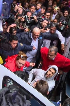 Luis Suarez (bottom-C-with hood) leaving hospital after being operated on May 22, 2014 in Montevideo.