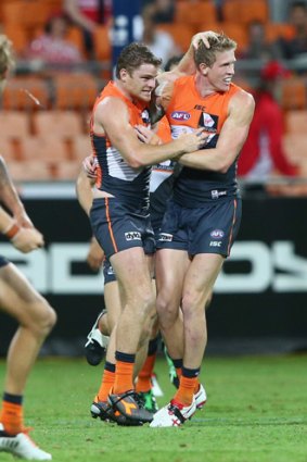 Youth and experience: Heath Shaw celebrates a goal with young gun Sam Frost.