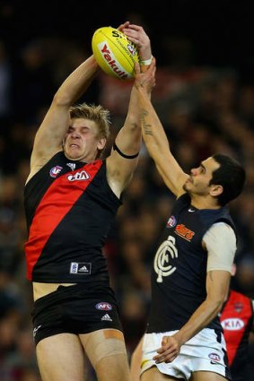Michael Hurley of the Bombers marks in front of Jeff Garlett of the Blues.