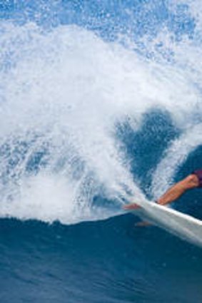 Swell guy … Johnson rides a wave off Oahu, Hawaii, in 2008.